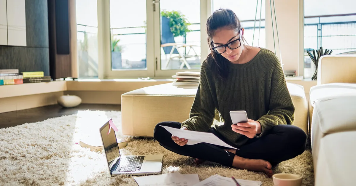 Person comparing savings account annual percentage yield options at home