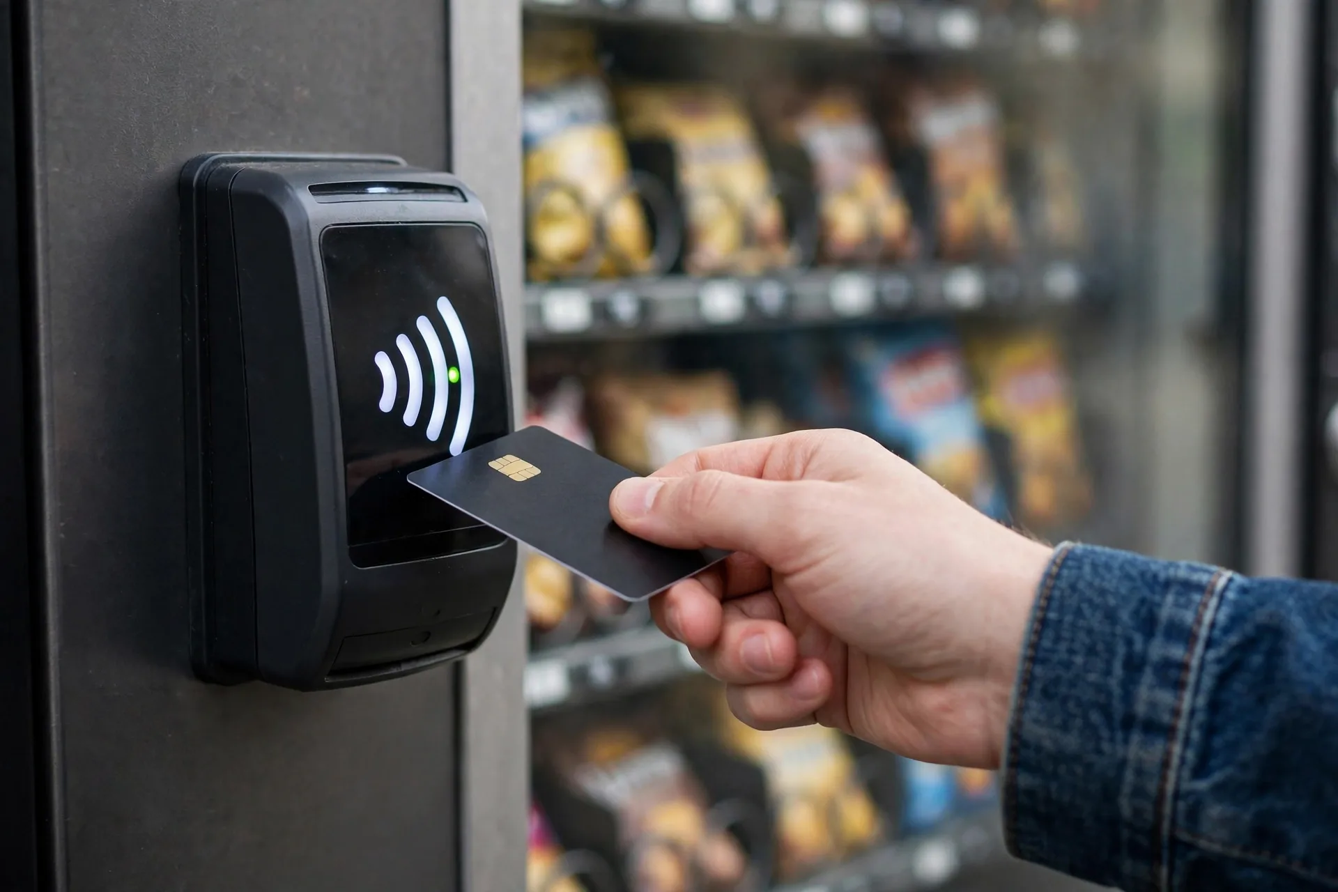 Customer tapping a card on a vending machine cashless reader for a vending machine business